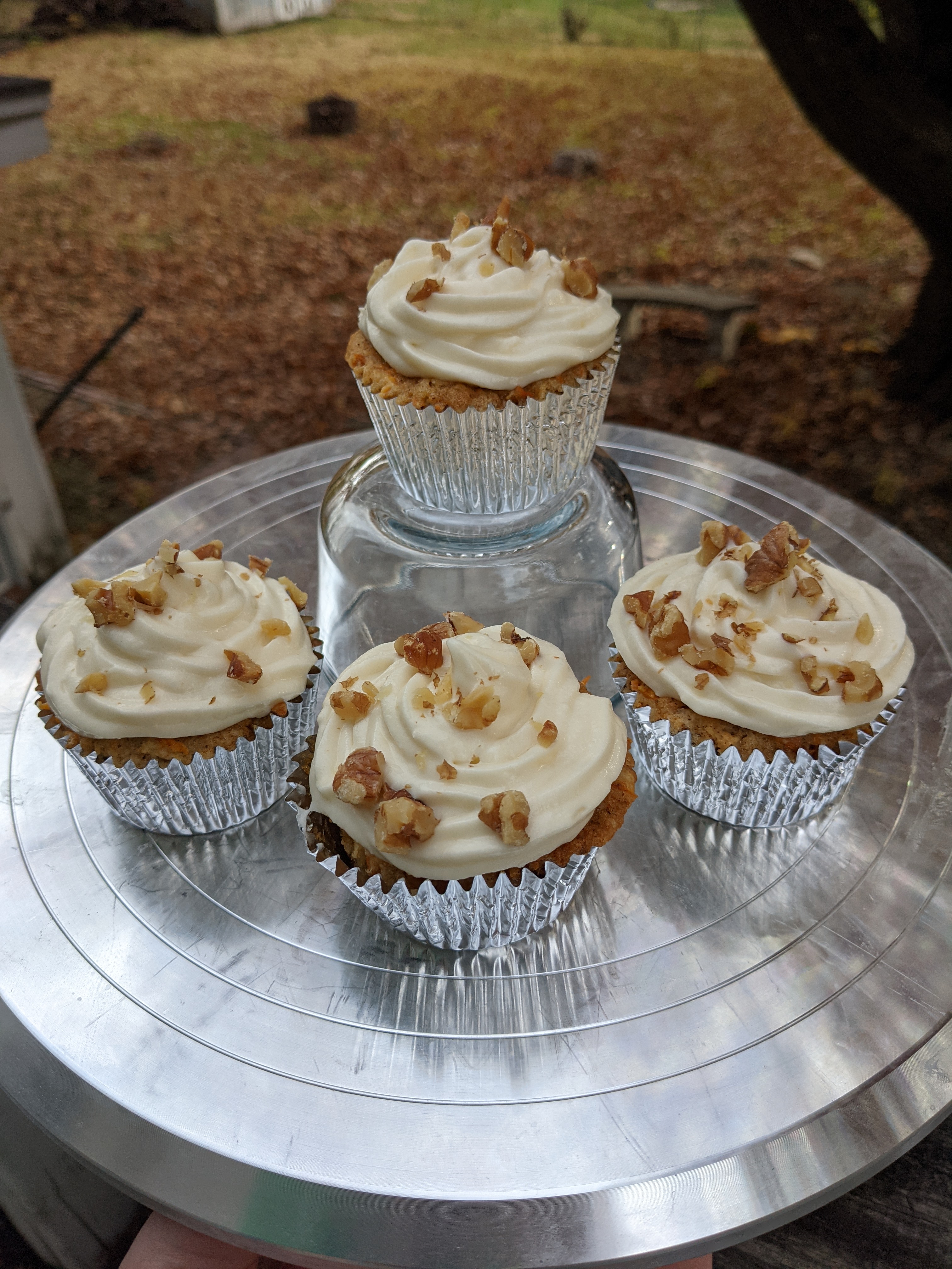 Four carrot cupcakes with walnut adornments