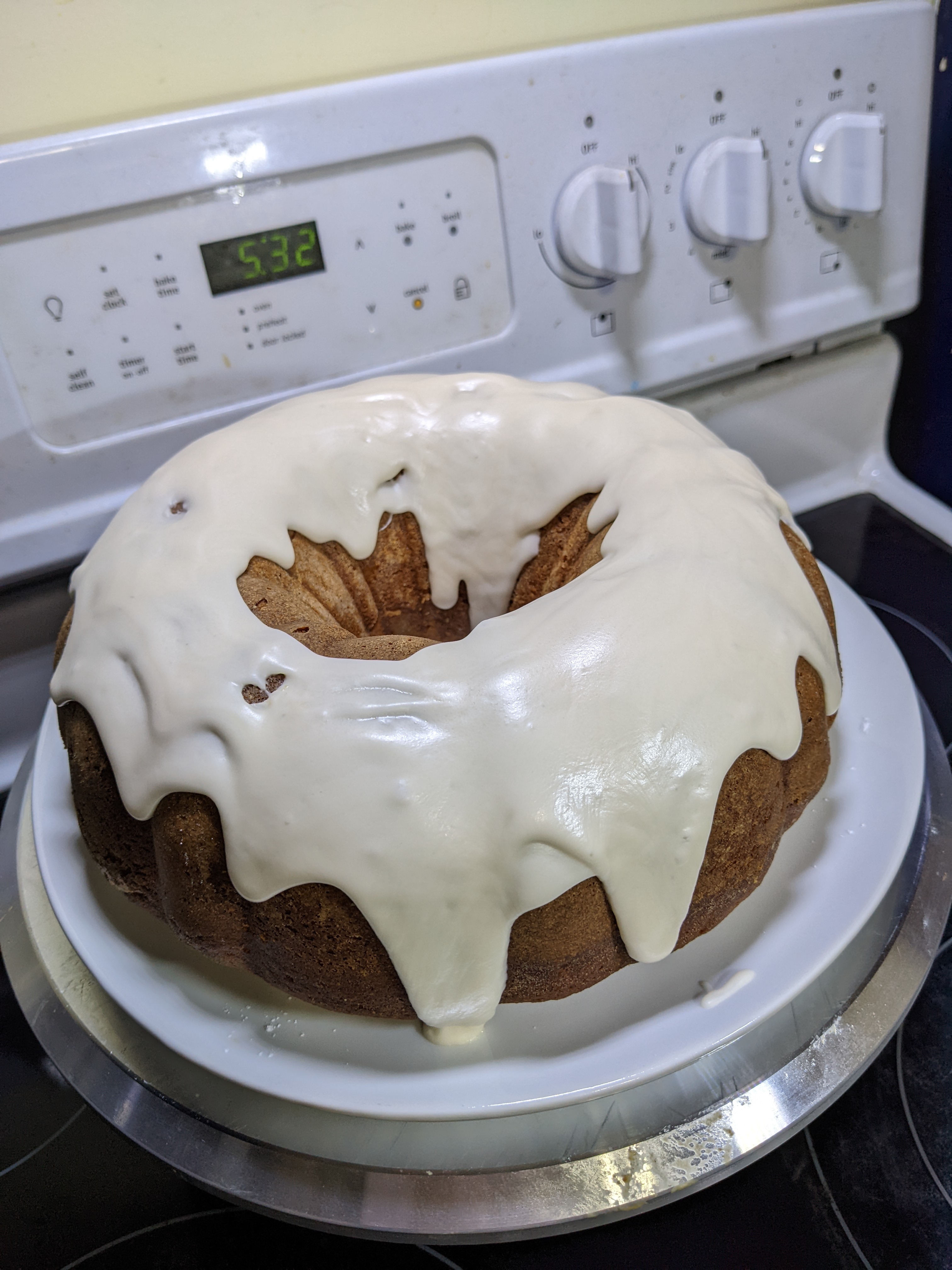 A bundt cake drizzled in a white glaze.