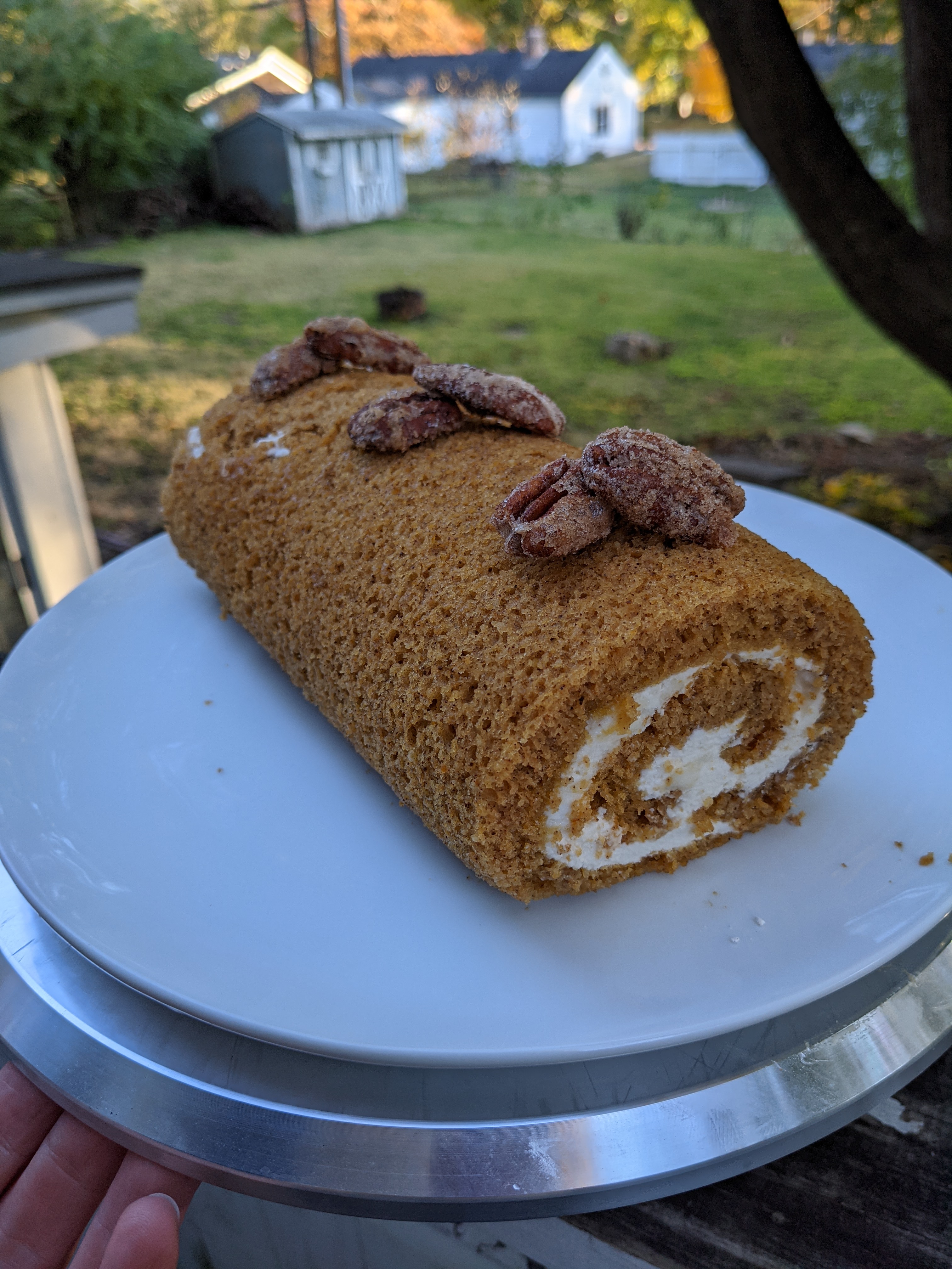 A pumpkin roll accented with spiced candied pecans