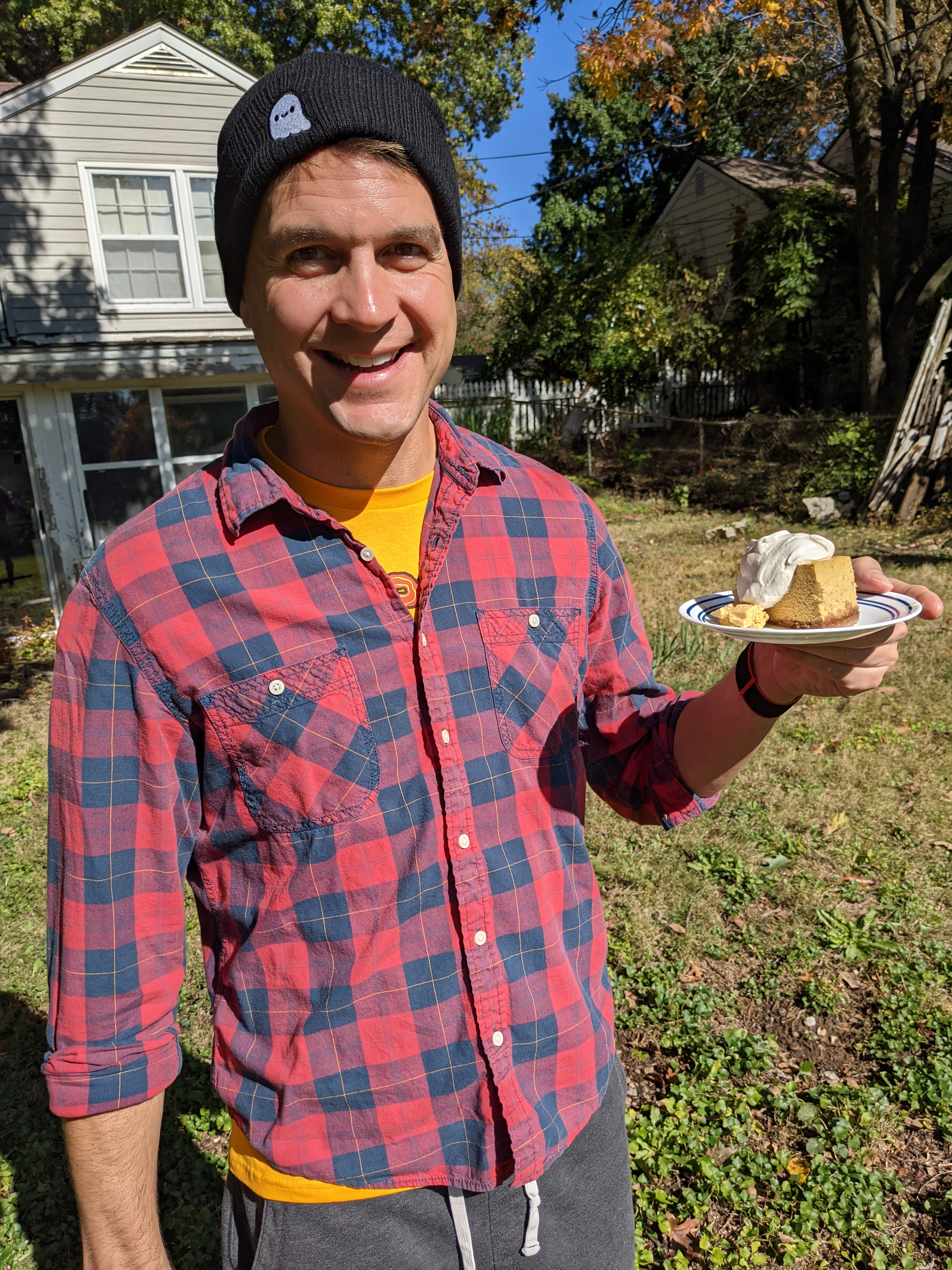 Jason holding a slice of spiced pumpkin cheesecake